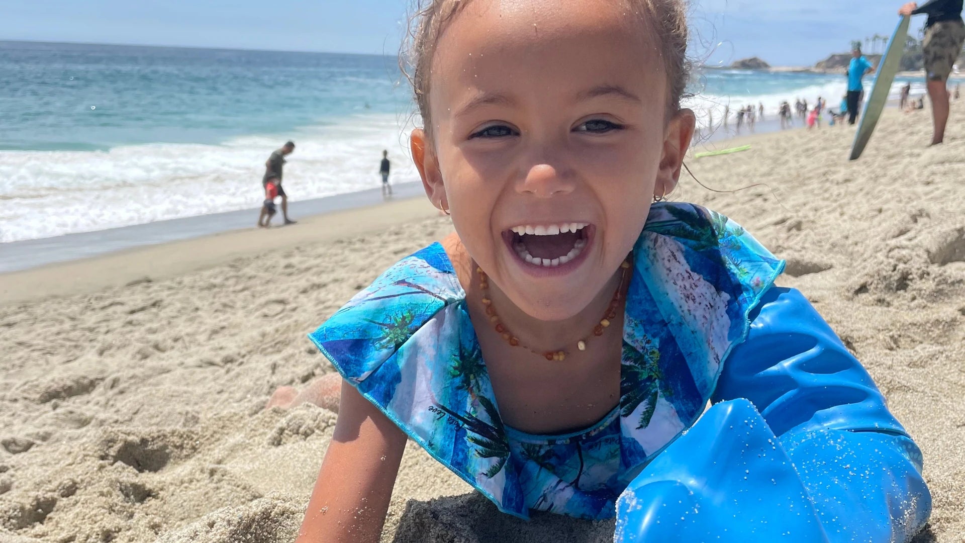 Child enjoying the beach while wearing a waterproof Bloccs cover
