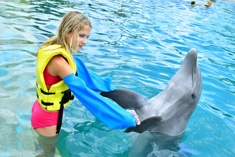 Child wearing Bloccs arm covers with a dolphin